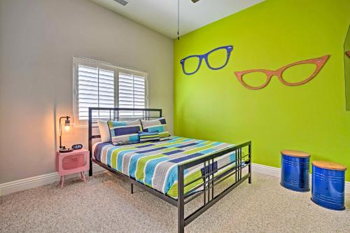 a bedroom with a bed with sunglasses on the wall at Adobe Escape with Private Spa and Pool in La Quinta! in La Quinta