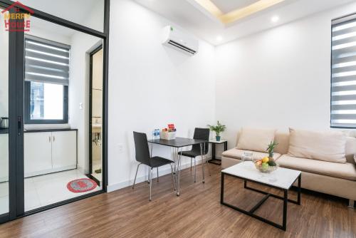a living room with a couch and a table at Merry House Imperia in Hai Phong