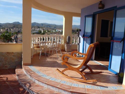 a patio with chairs and a table on a balcony at Hotel Mayarí Boutique Hotel in Calabardina
