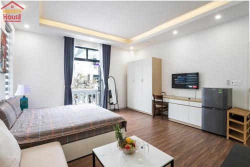 a living room with a bed and a tv at Merry House Imperia in Hai Phong