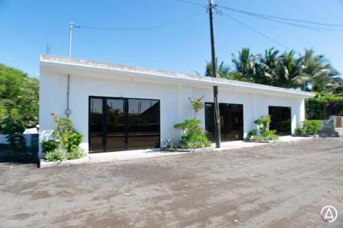 a white building with a lot of windows at Hotel Maya Jade in Monterrico