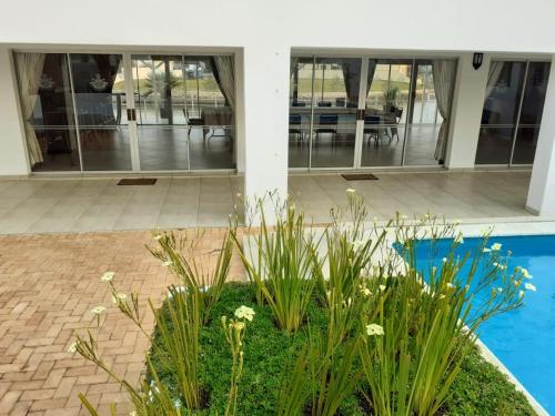 a house with a garden in front of a building at The Holy Hill Royal Alfred Marina in Port Alfred