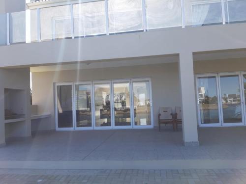 a large white building with glass doors and a table at The Holy Hill Royal Alfred Marina in Port Alfred