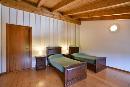 a room with two beds and two night stands at AGRITURISMO COLOMBARE TEBOI in Lazise
