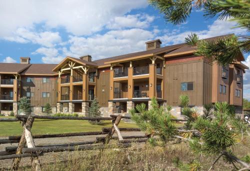 an exterior view of a building with a fence at WorldMark West Yellowstone in West Yellowstone
