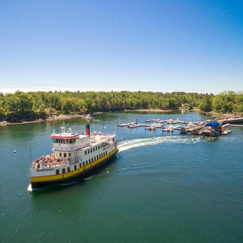 a ferry boat in a river with other boats at Inn at Diamond Cove in Portland
