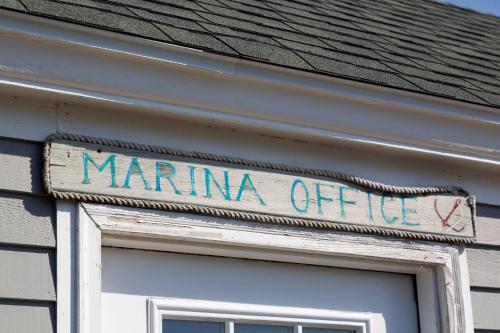 a sign that says marina offuce on the side of a building at Inn at Diamond Cove in Portland