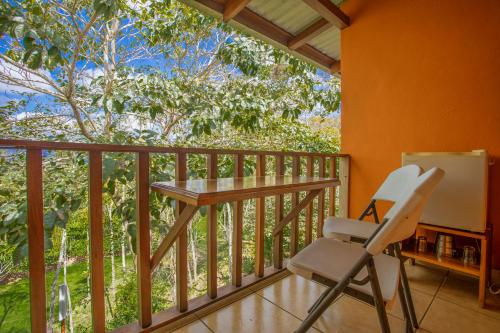 a room with a desk and a chair on a balcony at Hotel La Hacienda in Quesada
