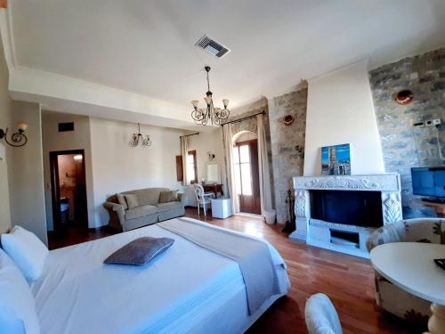 a large bedroom with a large bed and a fireplace at Areos Polis Boutique Hotel in Areopolis