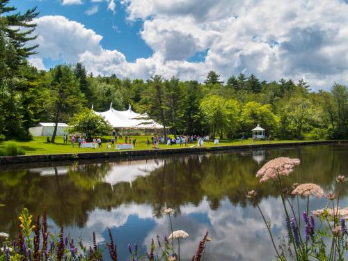 a view of a pond with a tent and people in a park at Inn at Diamond Cove in Portland