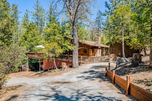 a house in the woods with a fence around it at Lily Haus in Idyllwild