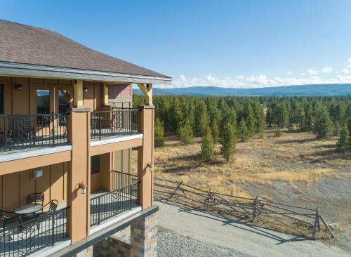 a view from the balcony of a house with trees at WorldMark West Yellowstone in West Yellowstone