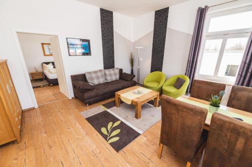 a living room with a couch and a table at Skerra Apartments "am Fitness-Studio" in Fehmarn