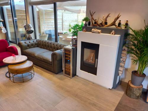 a living room with a couch and a fireplace at Charm Boutique Hotel in Satu Mare