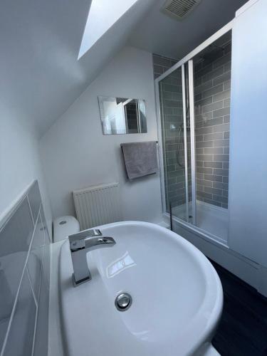 a white bathroom with a sink and a toilet at The Shires in Nuneaton