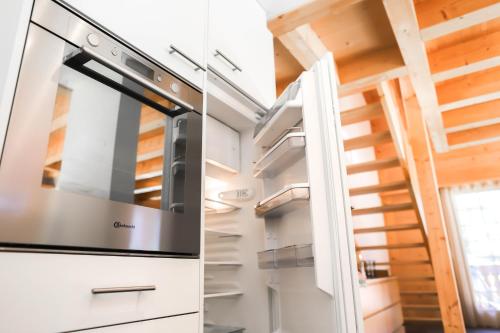 a kitchen with an oven and a staircase at Excellent flat with a fantastic view of the Eiger! in Grindelwald