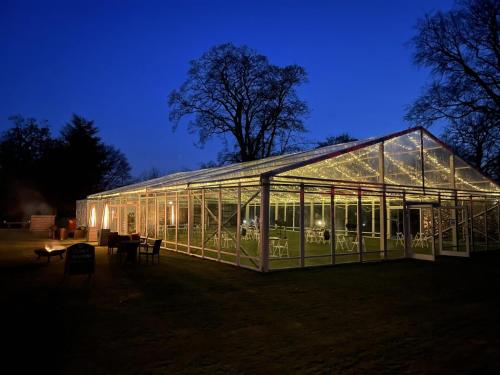 a greenhouse is lit up at night with lights at Hazlewood Castle & Spa in Tadcaster