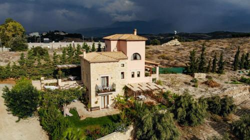 an aerial view of a house with a storm approaching at Kritamos Villa & Apartments in Kamilari