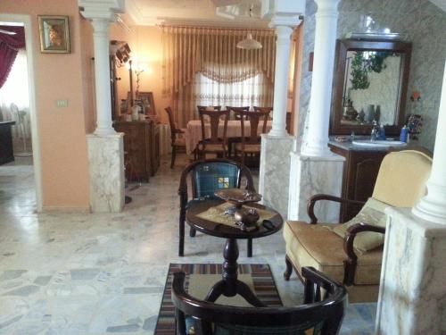 a living room with a table and chairs at Murshed Motel in Ash Shūnah ash Shamālīyah