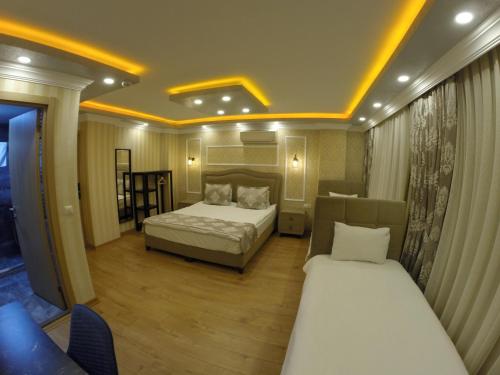 a hotel room with two beds and a couch at Meydan Suites in Istanbul