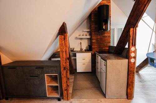 a kitchen in a attic with a counter and a sink at Agroturystyka Żuławiaczek in Nowy Dwór Gdański