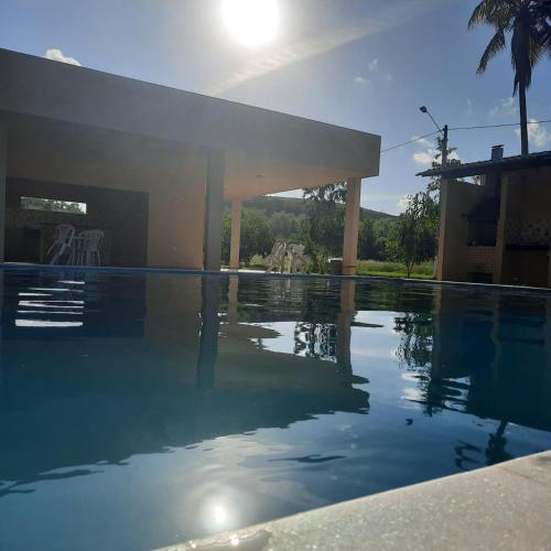a swimming pool in front of a house at CASA NOVA 2 in São José da Coroa Grande