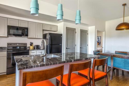 a kitchen with a large island with orange chairs at WorldMark Scottsdale in Scottsdale