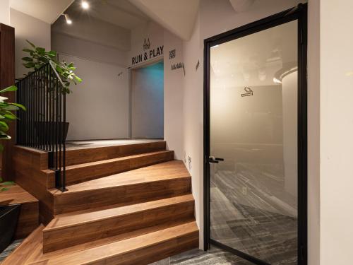 a glass door leading up to a stairway at EN HOTEL Hiroshima in Hiroshima
