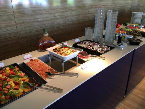 a buffet with many different types of food on a table at Aqua Apartman Panoráma in Velence