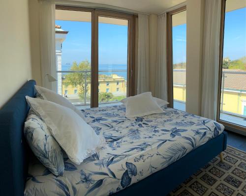 a bedroom with a bed with a view of the ocean at Panorama Apartment in Trieste