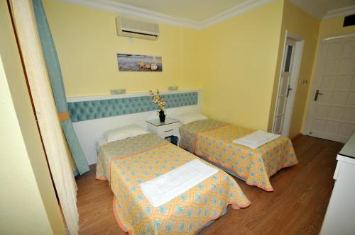 a room with two beds in a room at İlkiz Beach Hotel in Oludeniz