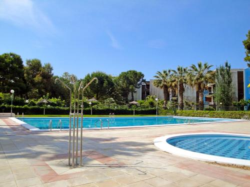 a palm tree in the middle of a swimming pool at Apartment Reus Mediterraneo by Interhome in Vilafortuny