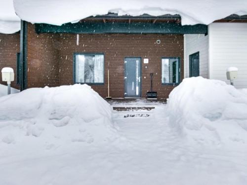 twee grote stapels sneeuw voor een huis bij Holiday Home Skivillas paljakka 5- - 3mh by Interhome in Kotila