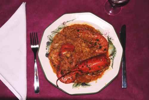 a plate of food with meat and sauce on a table at Posada Rural Ochohermanas in Las Fraguas