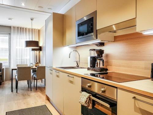 a kitchen with a sink and a table in a room at Holiday Home Levin kunkku b5 by Interhome in Levi