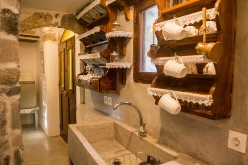 a bathroom with a sink and a counter with towels at Palaiokastro Traditional House in Mandrákion