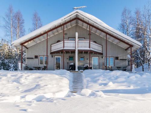 a large house with snow in front of it at Holiday Home Hallantytär b4 paritalo by Interhome in Hyrynsalmi