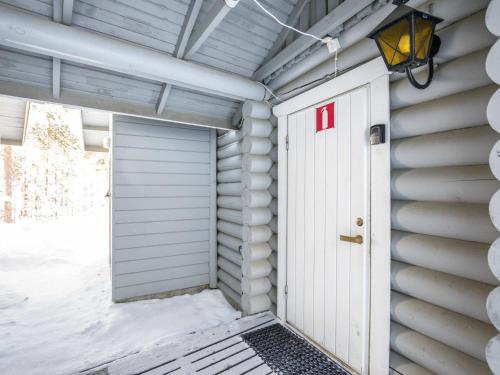a garage door with a red on it at Holiday Home Ukkohovi 3 paritalo by Interhome in Hyrynsalmi