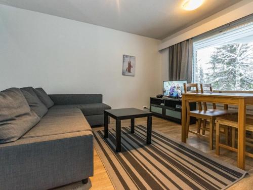 a living room with a couch and a table at Holiday Home Kotipaljakka a2 by Interhome in Kotila