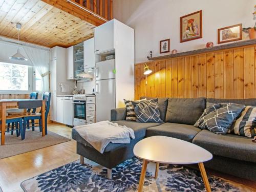 a living room with a couch and a table at Holiday Home Lomarivi c4 by Interhome in Kotila