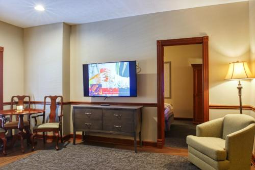 a living room with a television on a dresser at Carlisle Inn Walnut Creek in Walnut Creek