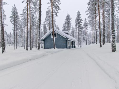 a small cabin in the snow in a forest at Holiday Home Ilves by Interhome in Kotila