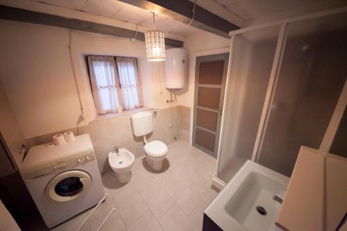 a small bathroom with a toilet and a sink at Maison Ville d'Aoste in Aosta