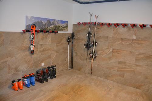 a room with skis and tools on the wall at Our's Living - modern Apartments with Sauna near Kitzbüheler Alpen ski lift in Hollersbach im Pinzgau