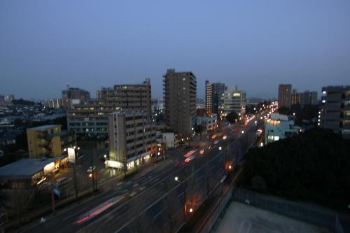 a view of a city at night with traffic at Green Rich Hotel Suizenji in Kumamoto