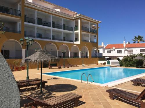 a swimming pool in front of a large building at T1 Altura, Piscina Terraço Prestige For Home in Altura