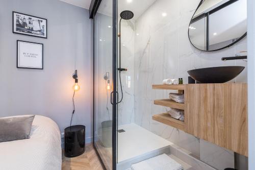 une salle de bain avec une douche en verre et un lavabo dans l'établissement 1 SU EDE - Dernier etage Ascenseur - 1 min Plage et Zone Pietonne, à Nice