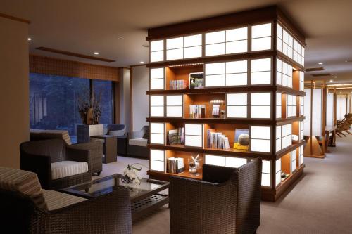 a room with a library with a table and chairs at Toba International Hotel Shiojitei in Toba