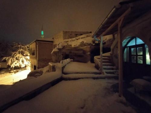 a house covered in snow at night at Deep Cave House in Urgup