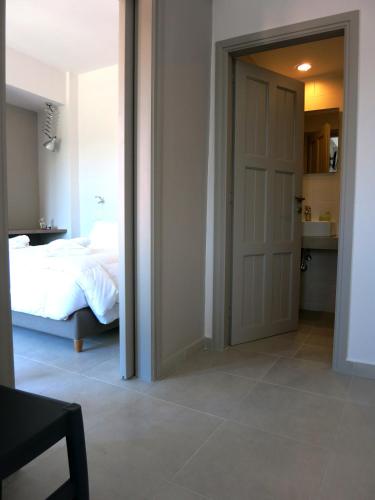 a bedroom with a door leading to a bed at Amaryllis in Plataniás